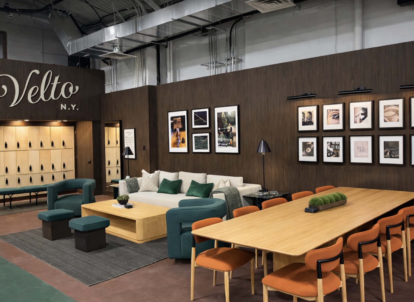 The Velto N.Y. member lounge with seating and gallery wall
