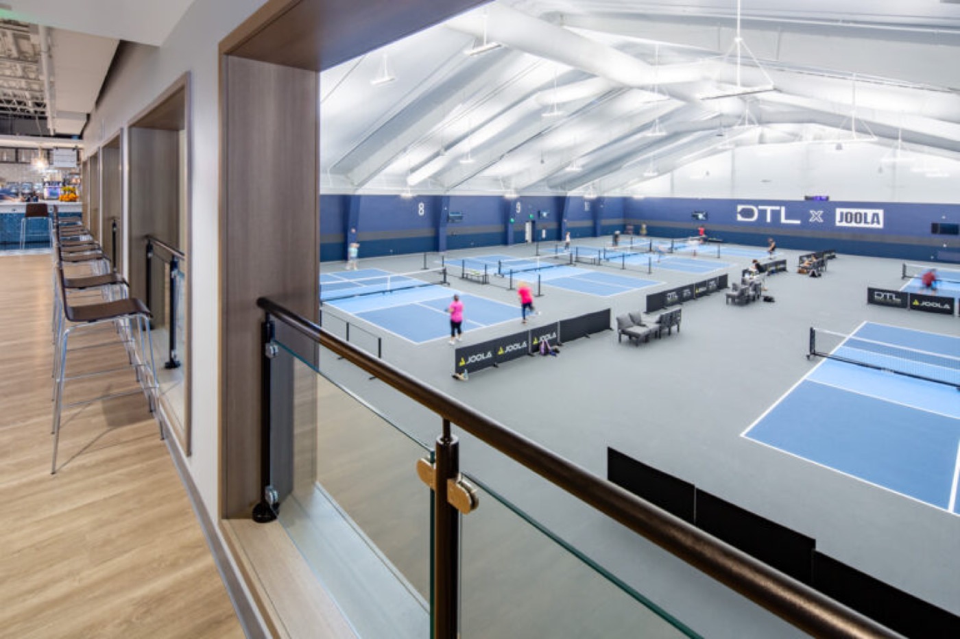 Balcony view overlooking play on the Down the Line x JOOLA courts