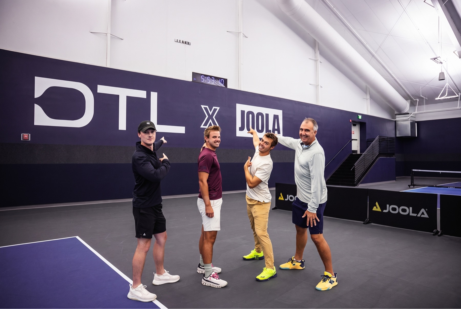 The Johns Design & Consulting founding team — Ben Johns, Collin Johns, West Shaw, and Andy Gensch — at a JDC-certified DTL x JOOLA pickleball facility